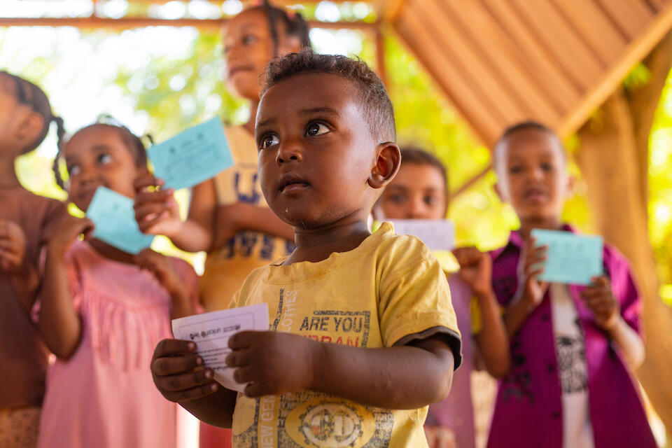 A child in Madani, Gezira state, Sudan, holds his vaccination card showing that he has been vaccinated for cholera as part of a UNICEF-supported emergency immunization campaign.