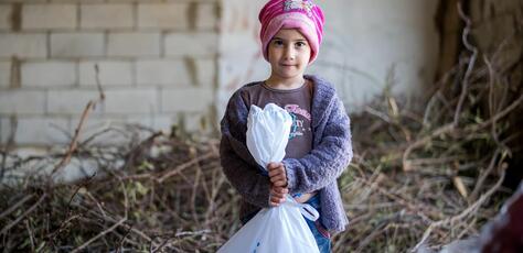 Amar, 5, holds a bag of supplies delivered by UNICEF to displaced families from South Lebanon in December 2023.